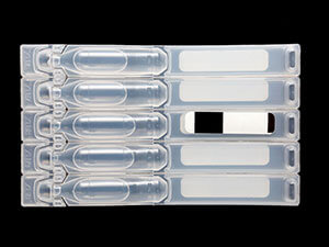Top labeling application for pharmaceutical vial packaging.